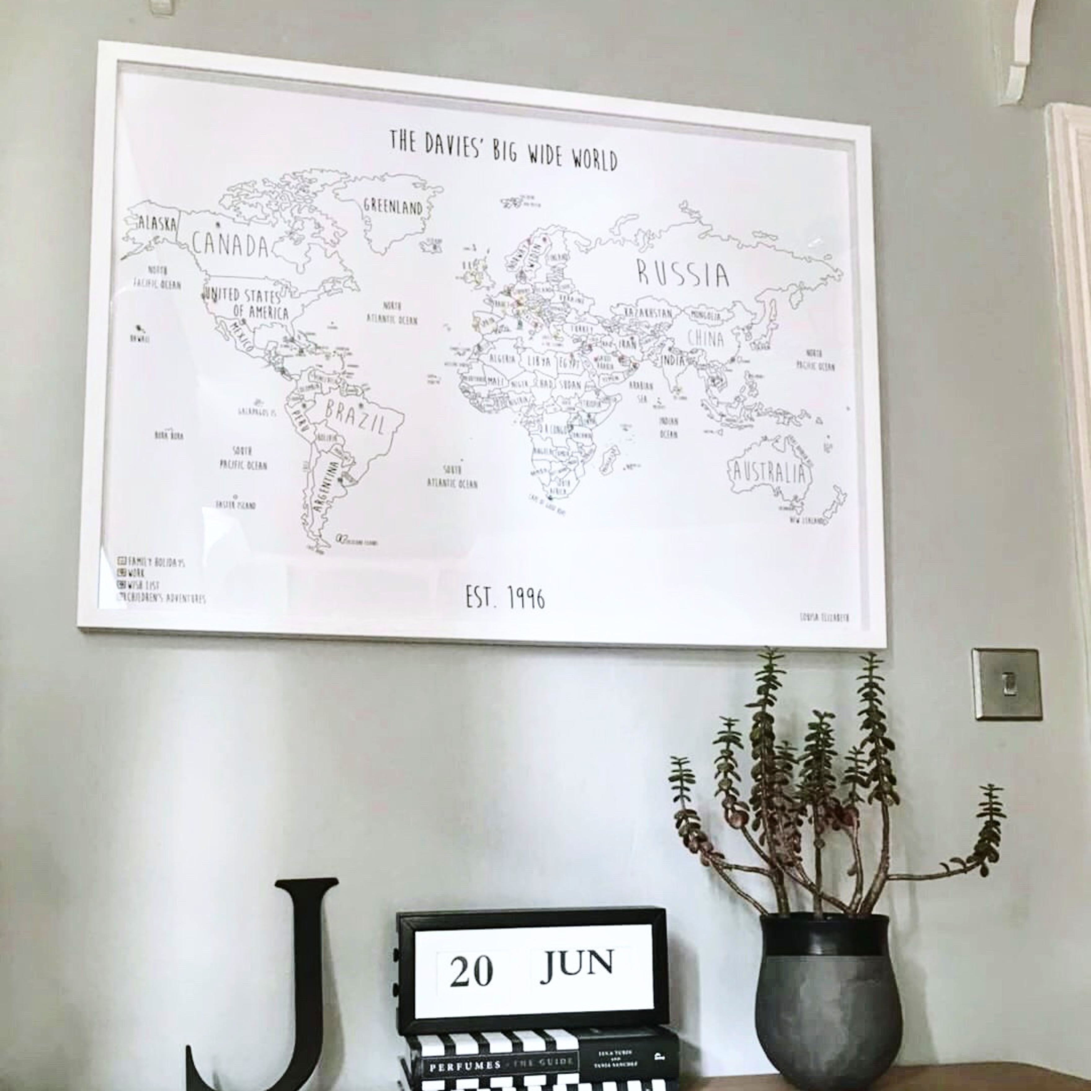 Personalised world pinboard map displayed in a customer’s home