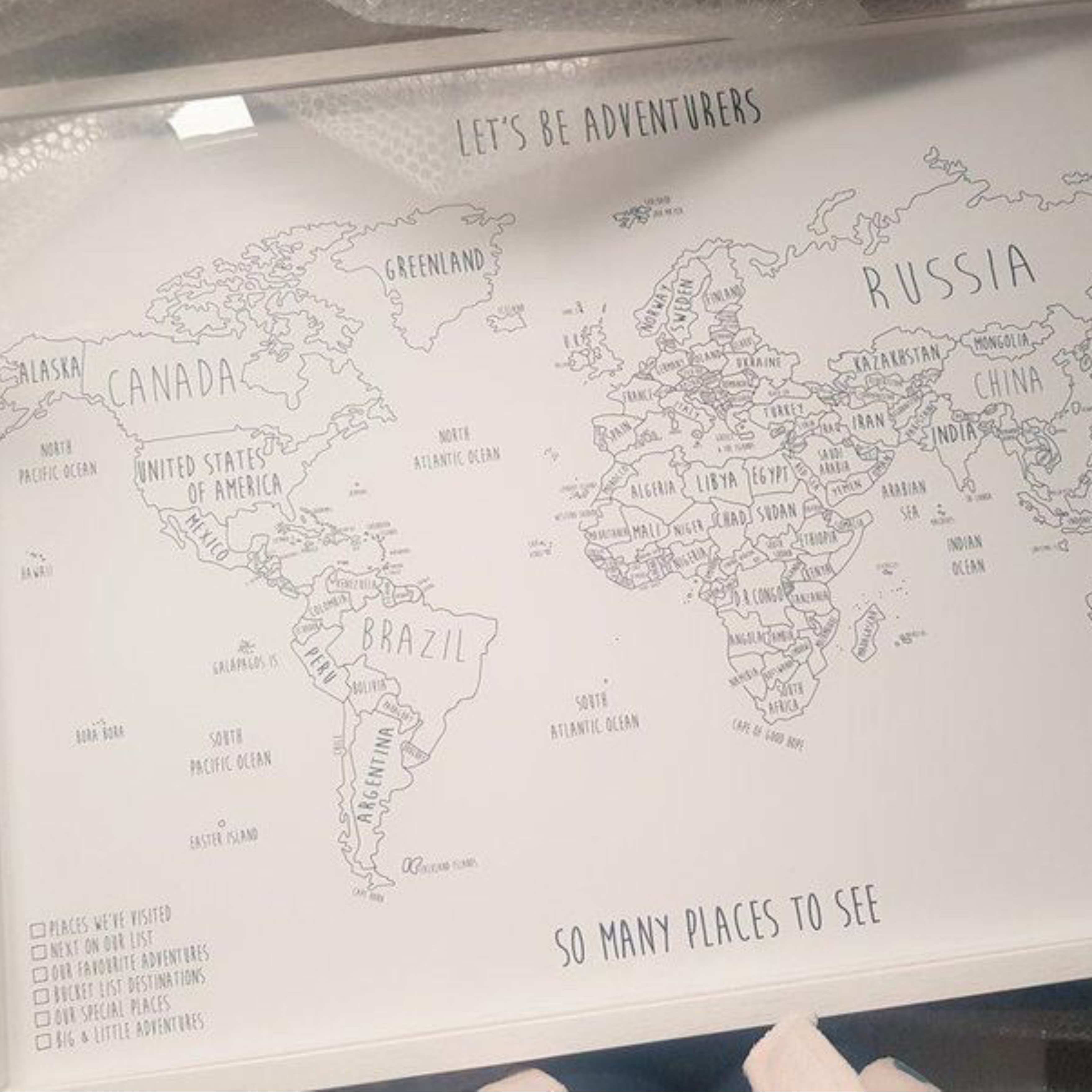 Personalised world pinboard map with travel pins
