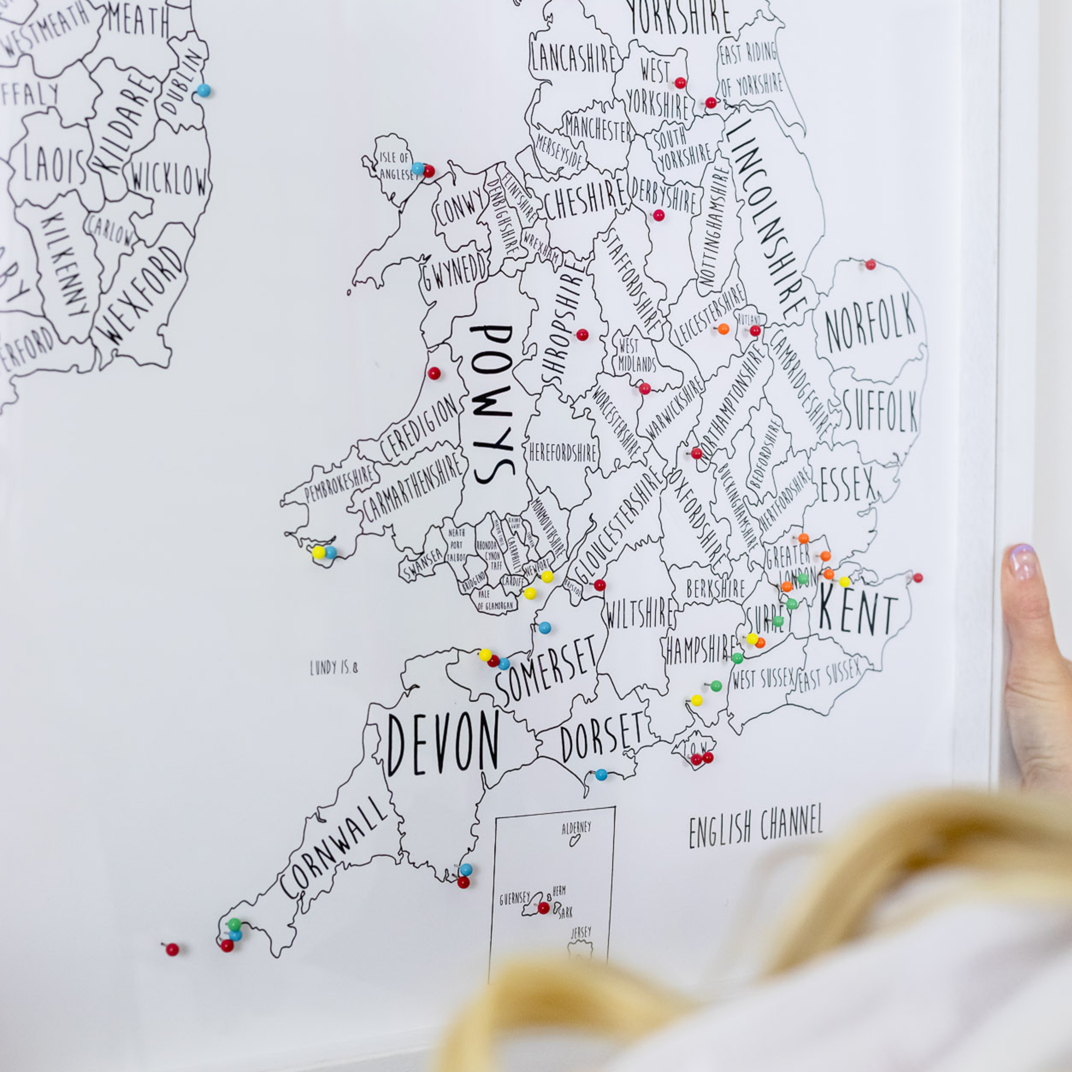 Map of England with highlighted locations, pointing towards a finger.
